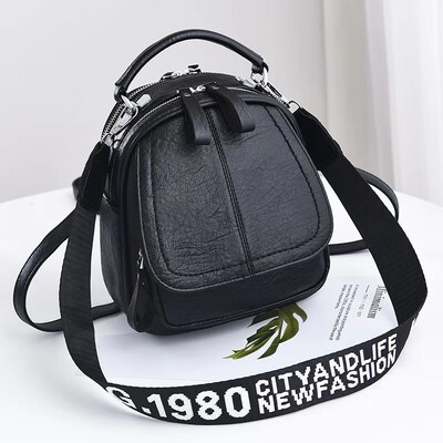 

A girl with a double shoulder bag a broadband shoulder bag a Korean version of a backpack a girl slanted a small round bag and