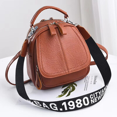 

A girl with a double shoulder bag a broadband shoulder bag a Korean version of a backpack a girl slanted a small round bag and