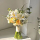 Wedding flowers holding flowers in hand, bride holding wedding pictures with tulips and gets a marriage certificate and simulated flowers taking photos of Chinese Valentine's Day. Pink and white flowers holding flowers
