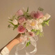 Wedding flowers holding flowers in hand, bride holding wedding pictures with tulips and gets a marriage certificate and simulated flowers taking photos of Chinese Valentine's Day. Pink and white flowers holding flowers