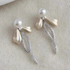 Bai Qixin 925 silver needle bow imitation pearl earrings for women light luxury niche high-end temperament earrings 2025 new earrings bow pearl tassel earrings