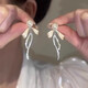Bai Qixin 925 silver needle bow imitation pearl earrings for women light luxury niche high-end temperament earrings 2025 new earrings bow pearl tassel earrings
