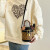 酷奇袋鼠（KUQIDAISHU）包包女包轻奢小众手提水桶包新款流行单肩圆筒包印花斜挎包礼物 棕色 送丝